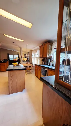 a kitchen with stainless steel appliances granite countertop a refrigerator and a stove