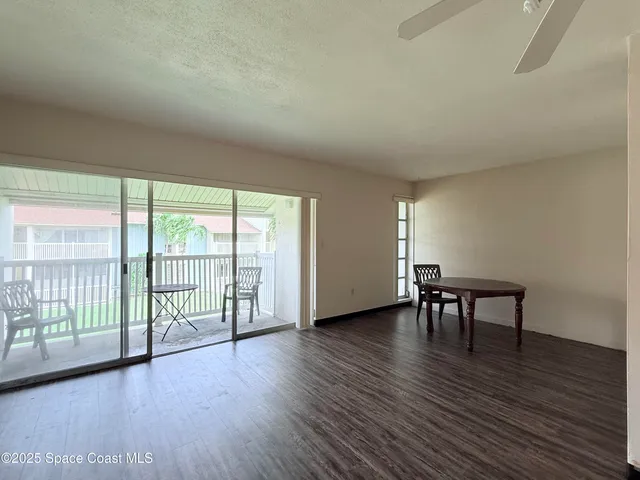 a view of room with furniture and wooden floor