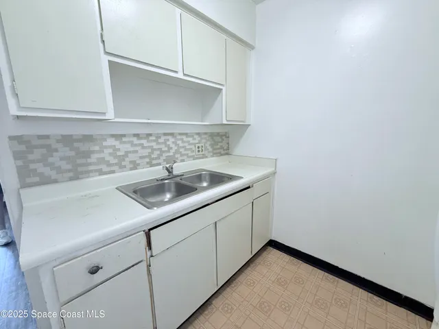 a kitchen with a sink and cabinets