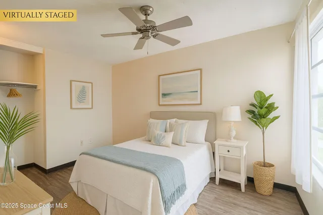 a bedroom with a bed and a potted plant