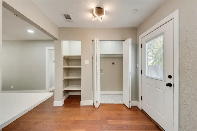 a view of an empty room with a closet