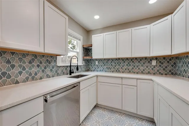 a kitchen with a sink and cabinets