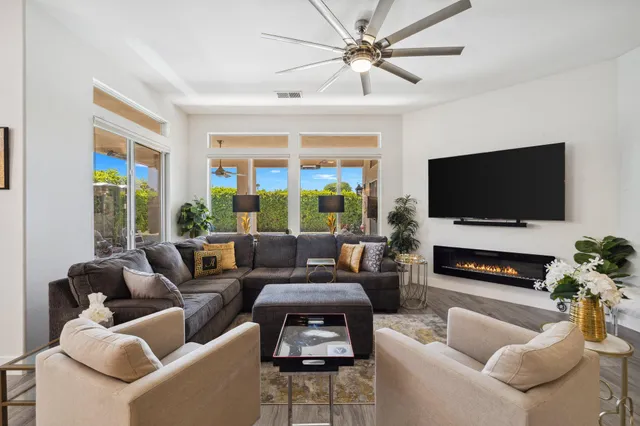 a kitchen with stainless steel appliances kitchen island a table chairs refrigerator sink and microwave