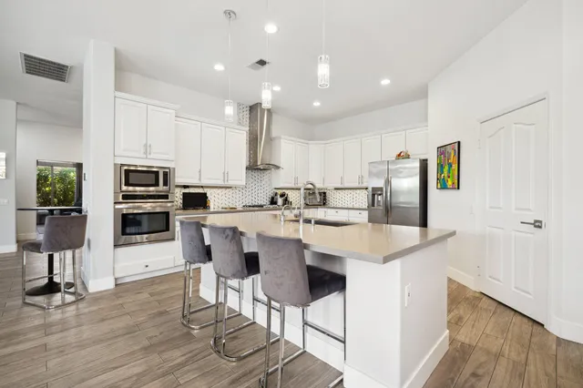a kitchen with a large window and furniture