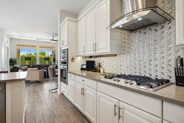 a dining room with furniture a chandelier and wooden floor
