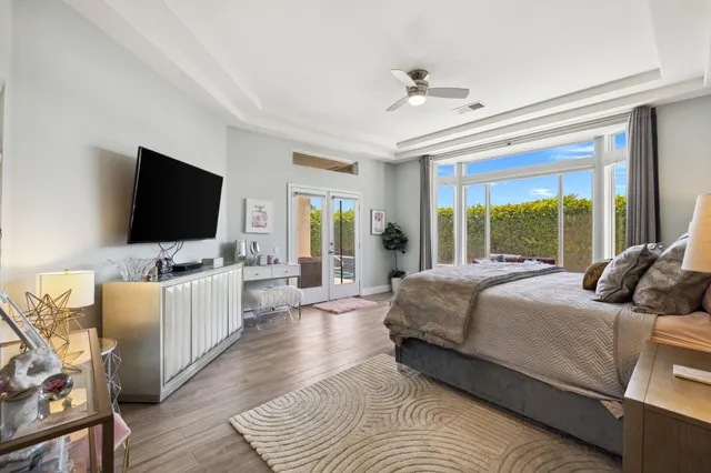 a living room with furniture and a floor to ceiling window