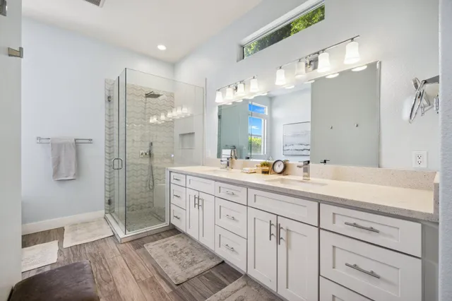 a bedroom with a bed and glass windows