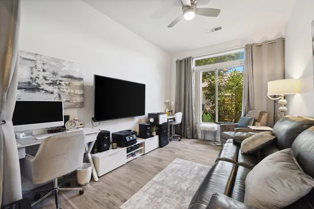 a balcony with furniture and a potted plant