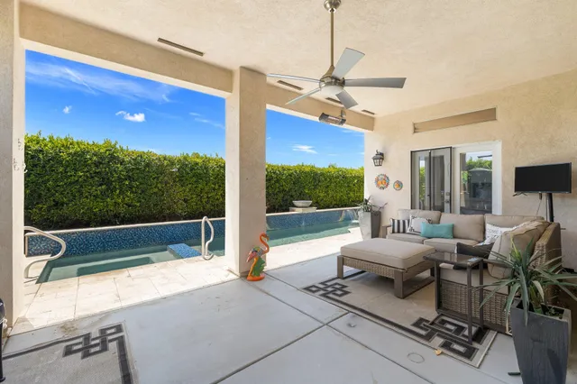 a view of a house with backyard and sitting area