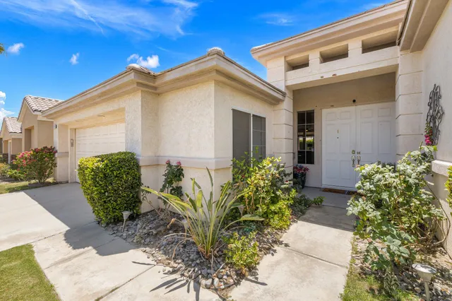 a living room with lots of furniture and kitchen view