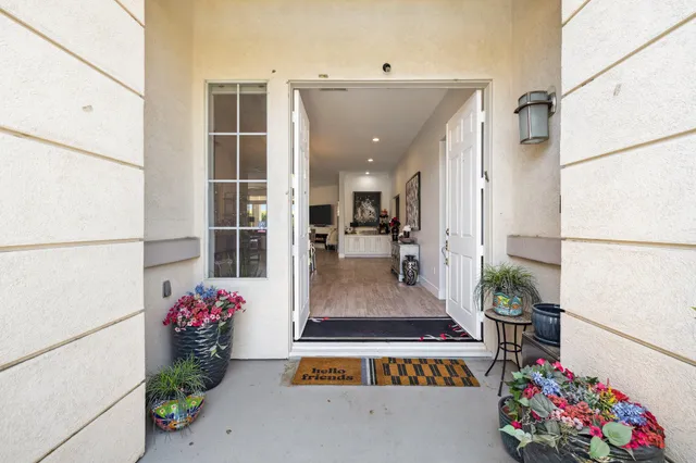 a view of a kitchen with furniture and wooden floor