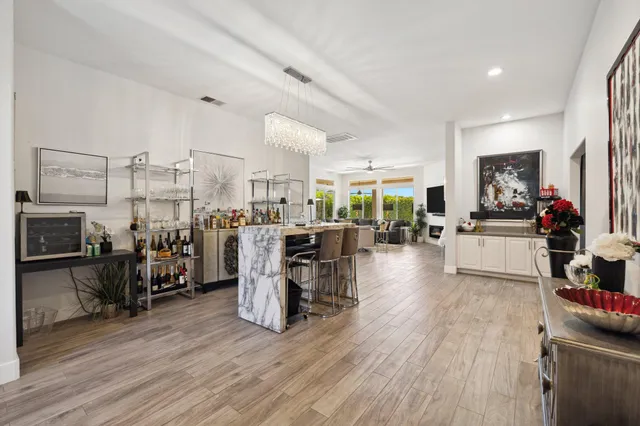 a living room with furniture a flat screen tv and a large window