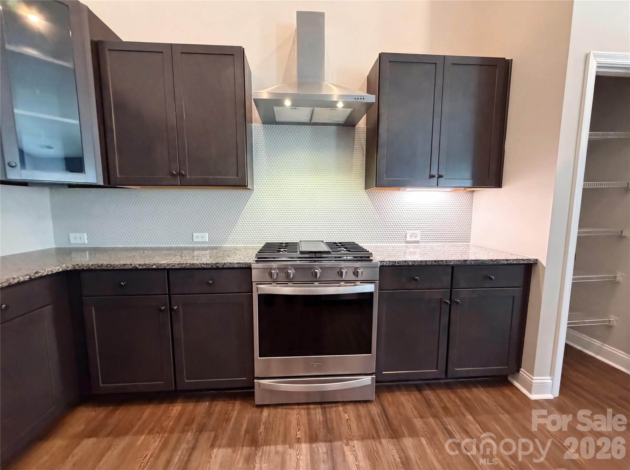 1321 Fishing Creek Road Clover, SC 29710 - Photo 7 of 19 a kitchen with stainless steel appliances granite countertop wooden cabinets a stove a sink and dishwasher