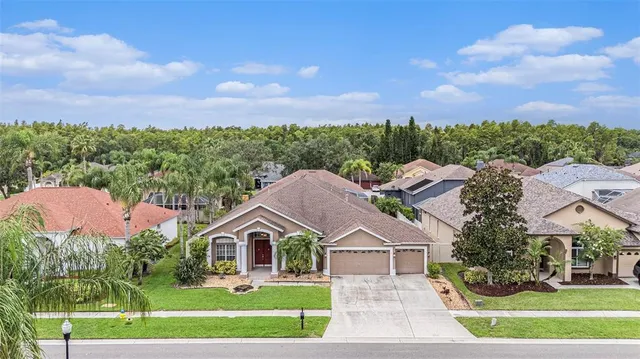 an aerial view of a house with a yard