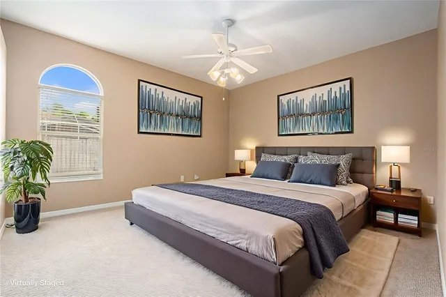 a spacious bedroom with a bed and a window