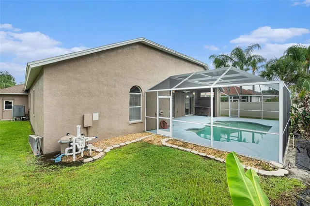 a view of a house with backyard sitting area and garden