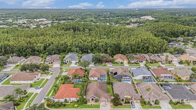 an aerial view of residential houses with outdoor space and parking