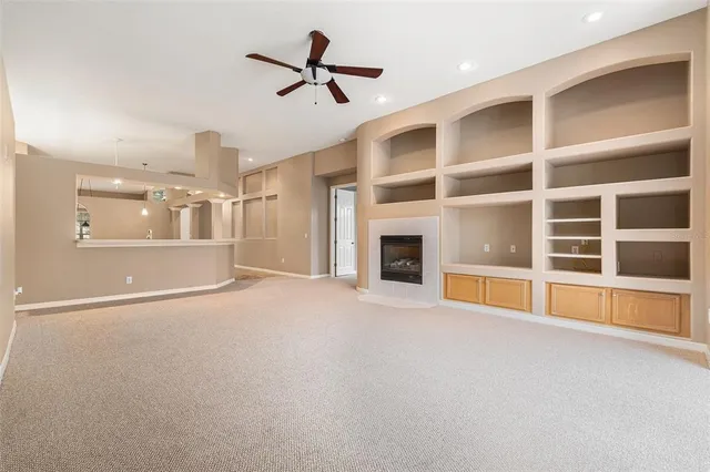 a view of an empty room with a fireplace and a window