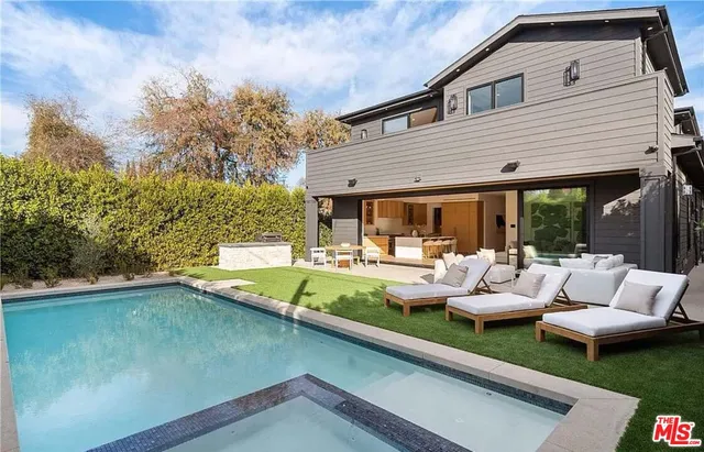 a view of a patio with couches table and chairs and potted plants