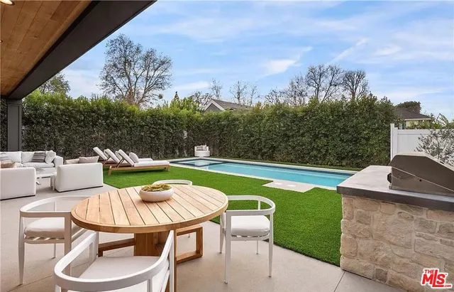 a view of a chairs and table in patio