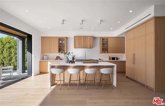 a large kitchen with a table and chairs