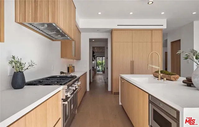 a kitchen with a sink stove and cabinets