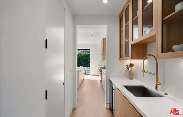a kitchen with stainless steel appliances a sink and a refrigerator