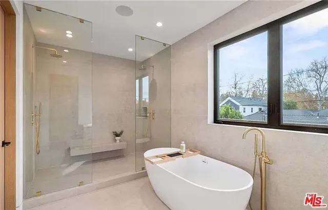 a bathroom with a bathtub and shower