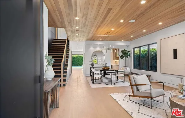 a dining room with furniture and wooden floor