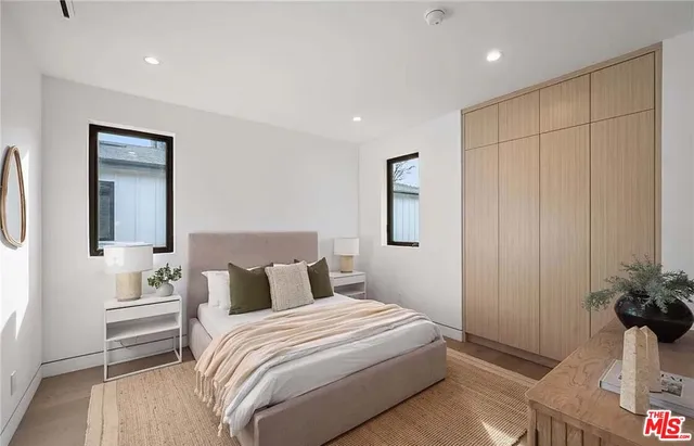 a bedroom with a bed and a potted plant