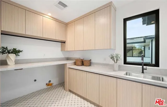 a kitchen with a sink cabinets and window