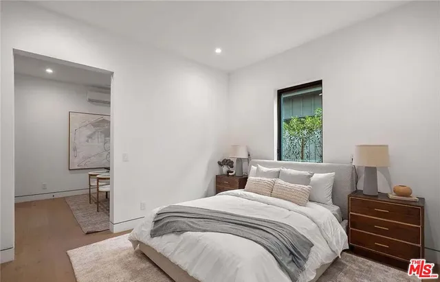 a bedroom with a bed and a night stand