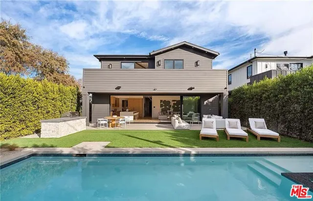 a view of swimming pool with outdoor seating and a potted plant