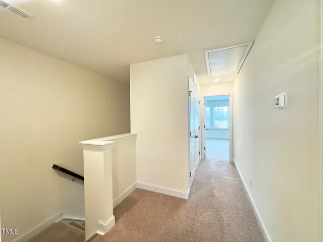 an empty room with a empty space and windows