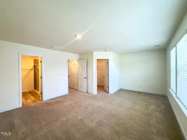 a bathroom with a double vanity sink a mirror and a shower