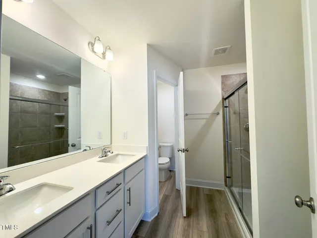 a bathroom with a glass shower door