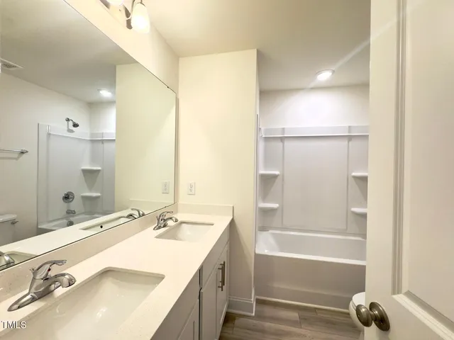 a bathroom with a bathtub and a sink