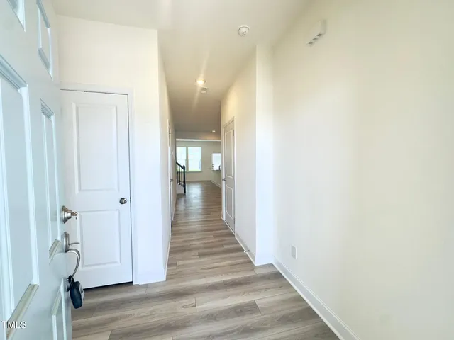 a view of a hallway with wooden floor