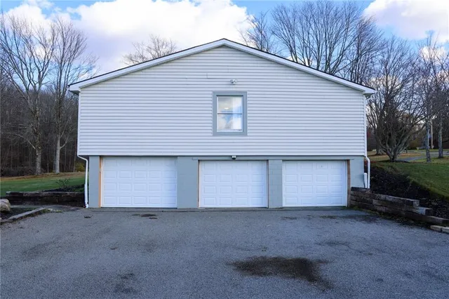 a front view of house with yard and trees