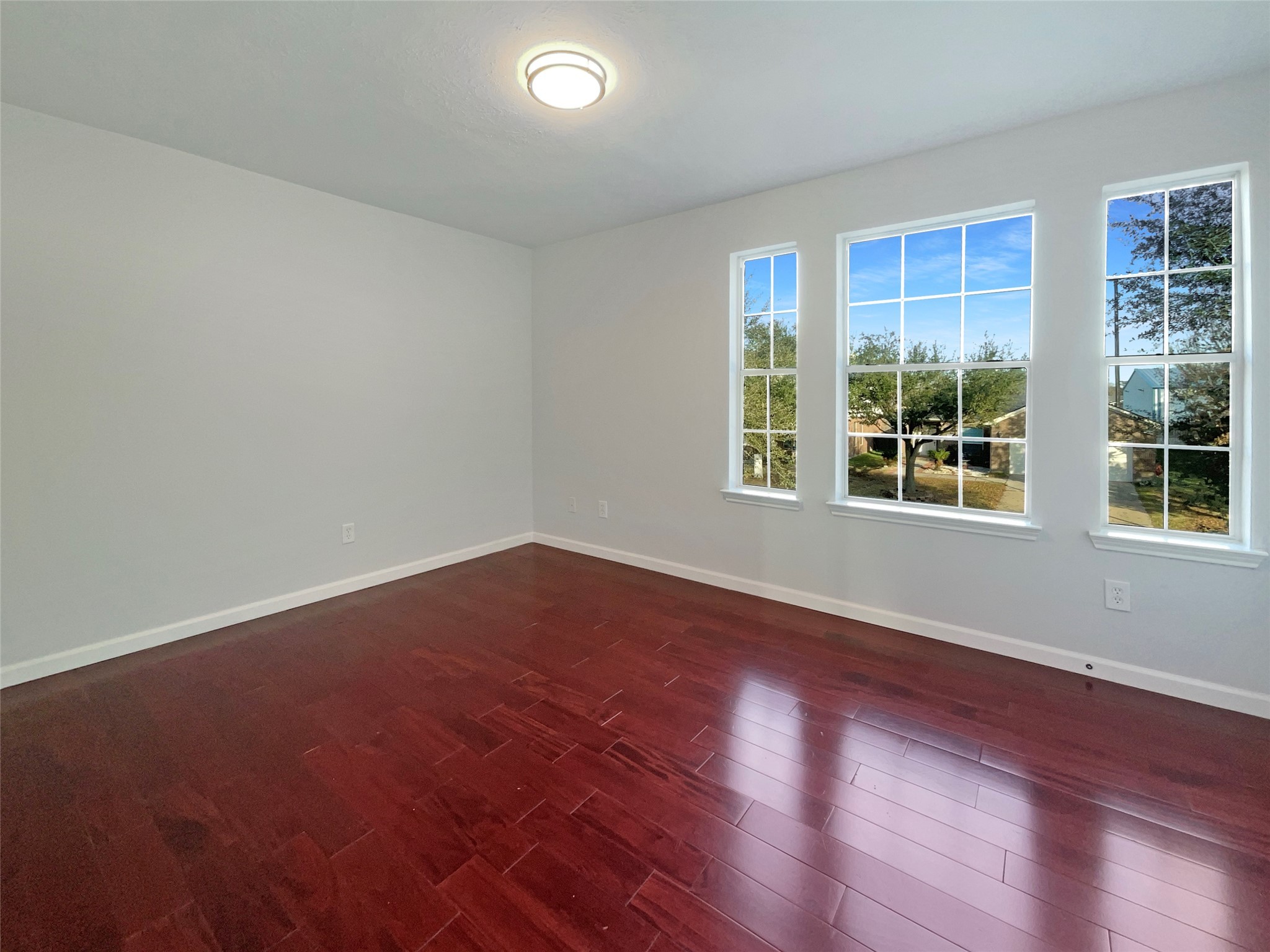 12111 Virline Lane Houston, TX 77067 - Photo 14 of 22 a view of an empty room with wooden floor and a window