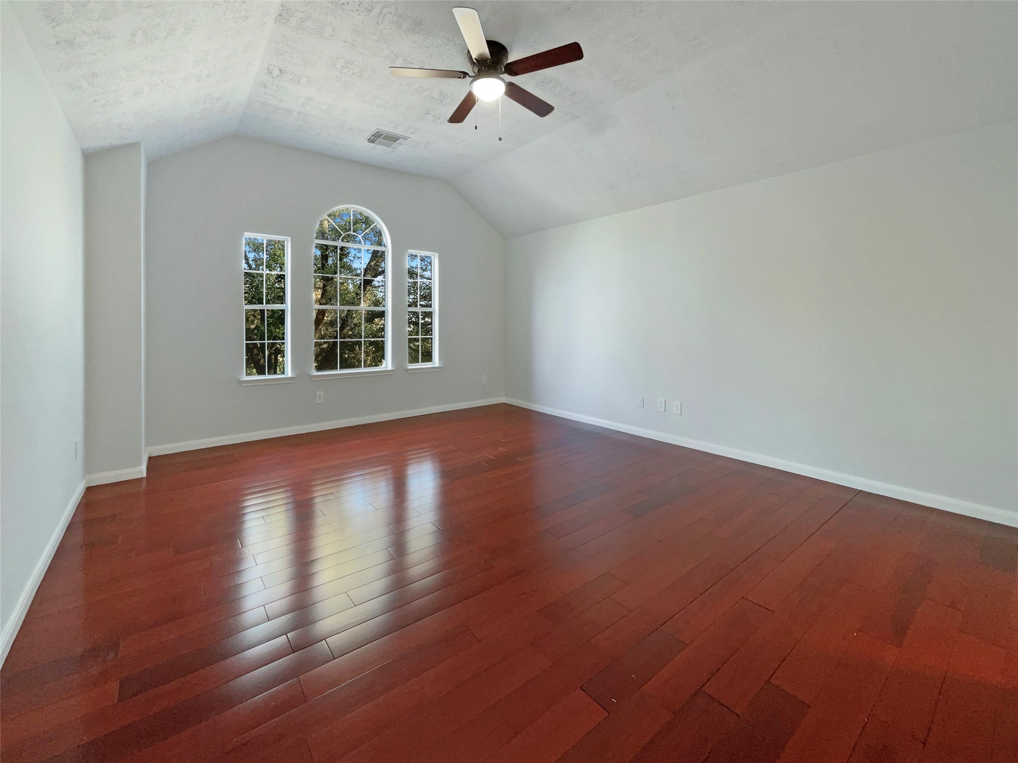 12111 Virline Lane Houston, TX 77067 - Photo 15 of 22 an empty room with wooden floor fan and windows