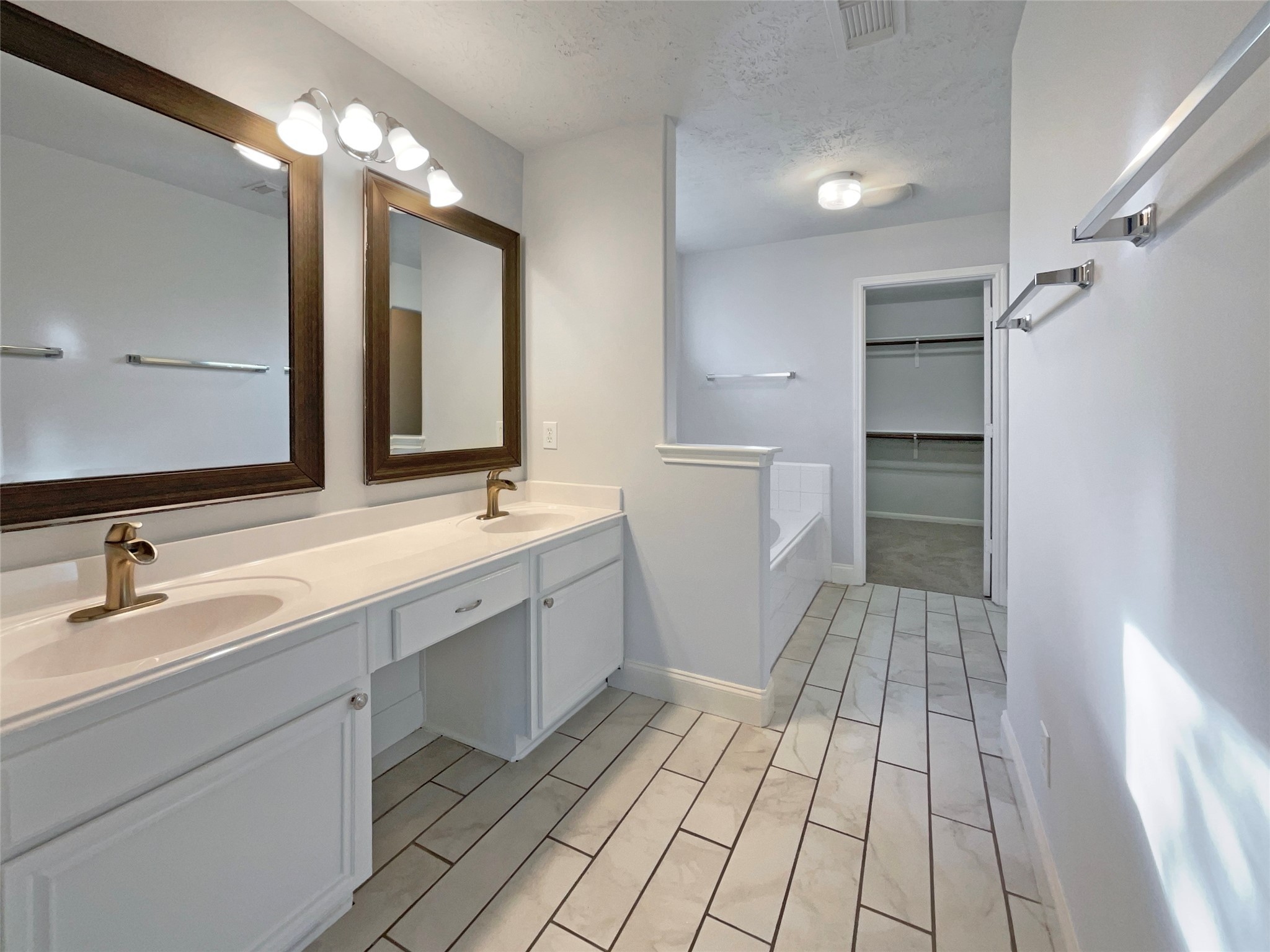 12111 Virline Lane Houston, TX 77067 - Photo 16 of 22 a spacious bathroom with a double vanity sink and a mirror