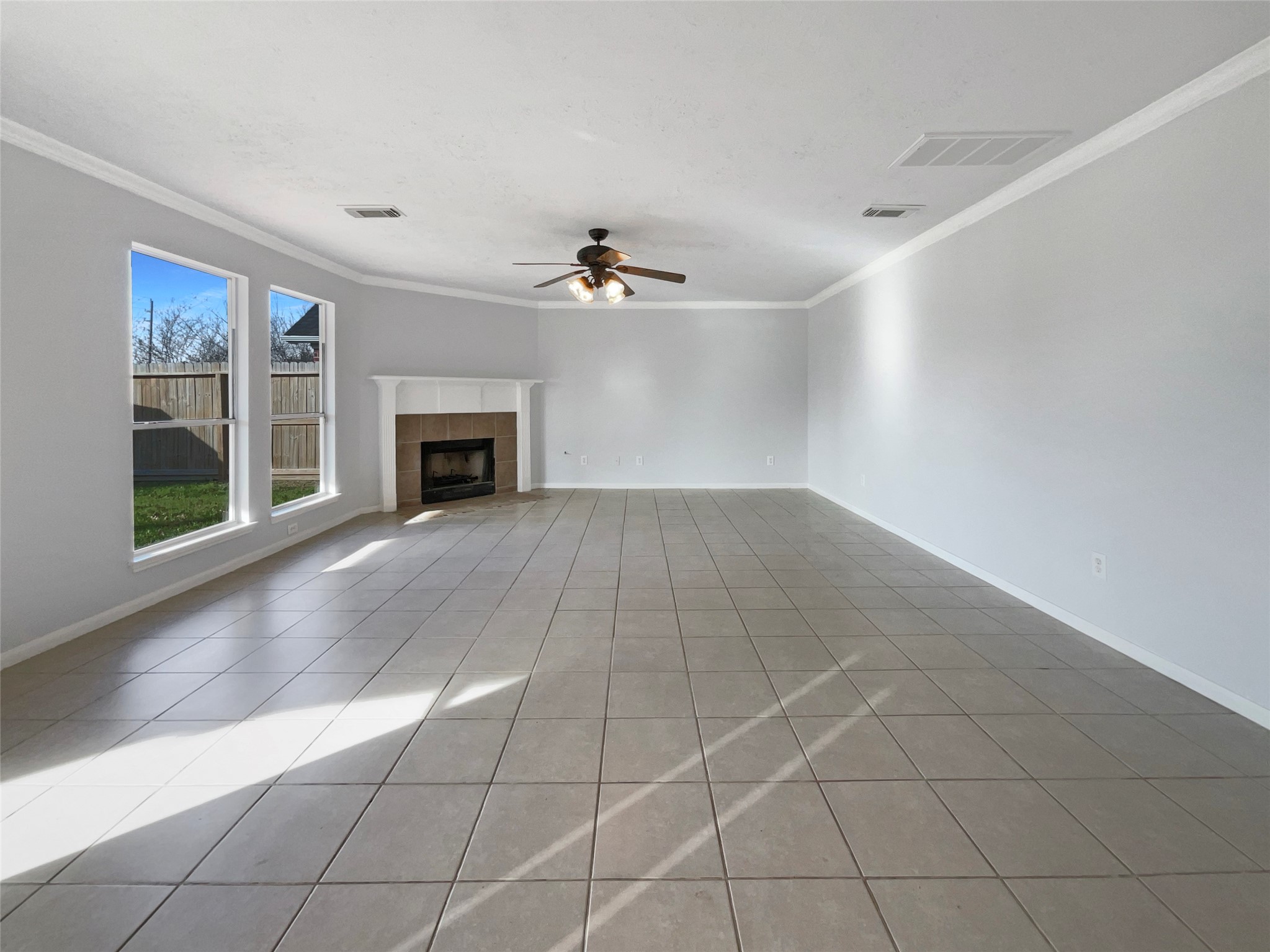 12111 Virline Lane Houston, TX 77067 - Photo 3 of 22 an empty room with windows and fireplace