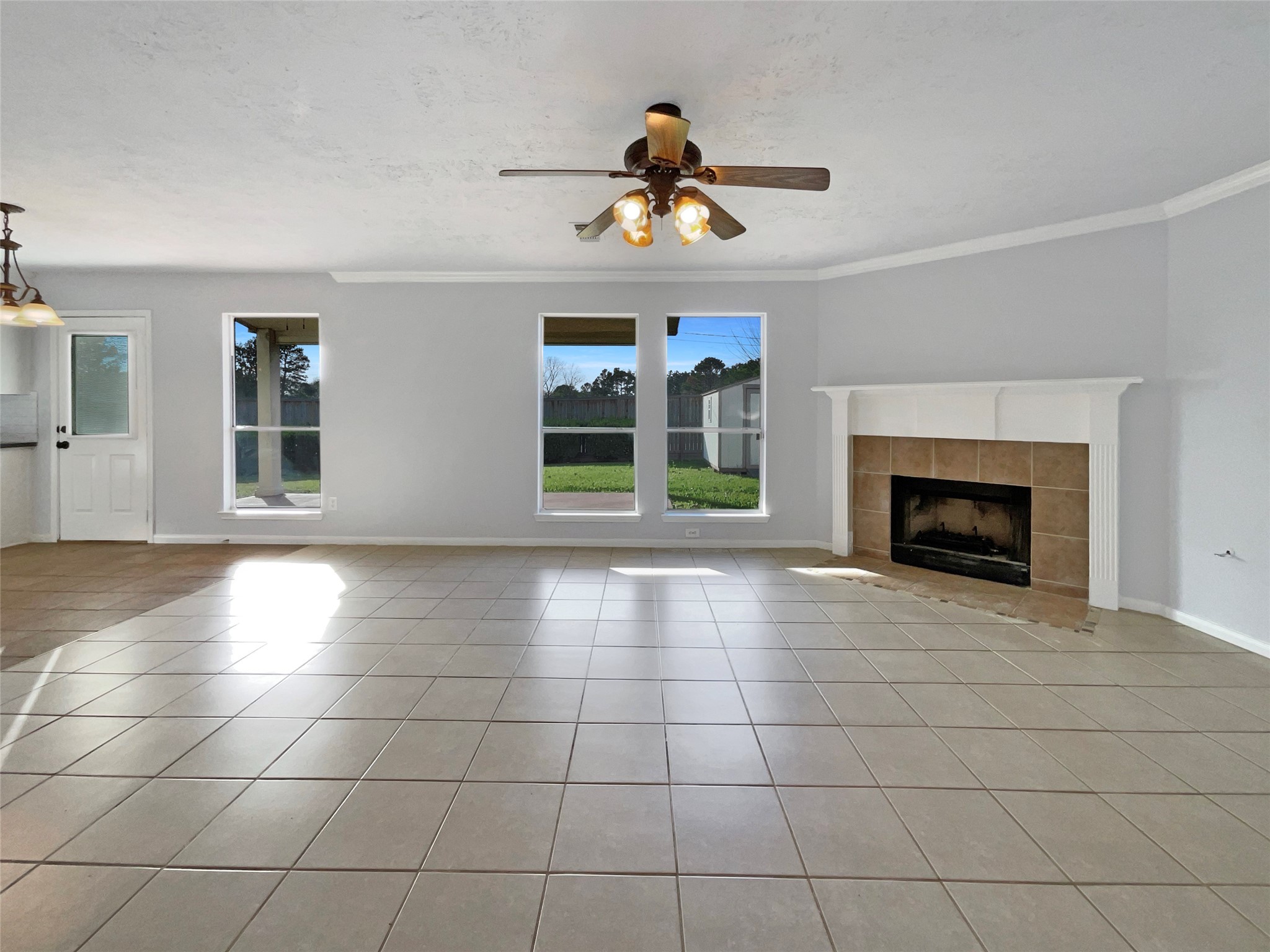 12111 Virline Lane Houston, TX 77067 - Photo 9 of 22 a view of an empty room with window and fireplace