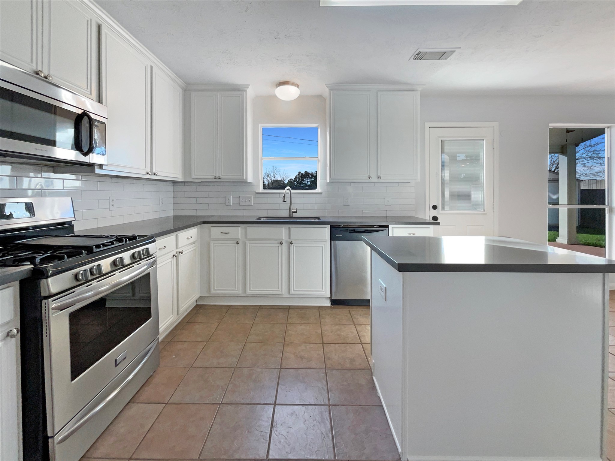 12111 Virline Lane Houston, TX 77067 - Photo 10 of 22 a kitchen with a sink stove top oven and cabinets