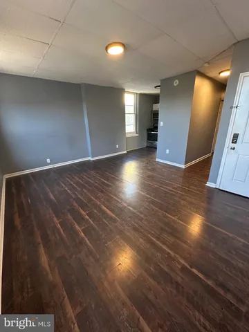 a view of room with window and wooden floor