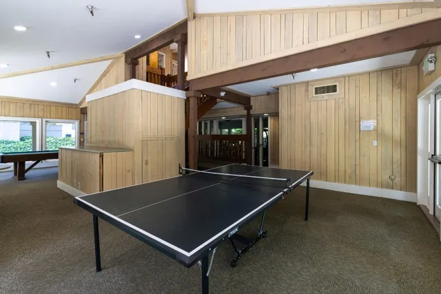 a room with pool table and windows