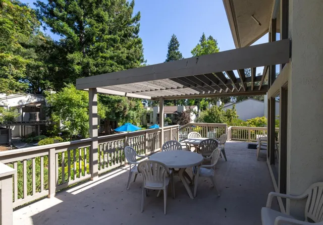 a view of a patio with table and chairs and potted plants