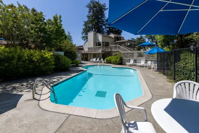 a front view of a house with a tree and fence
