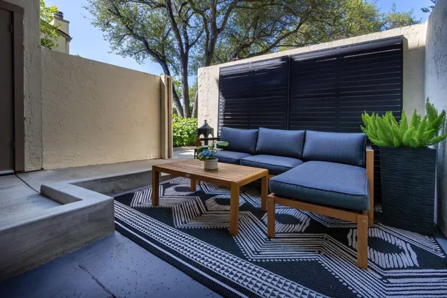a roof deck with wooden floor and a potted plant